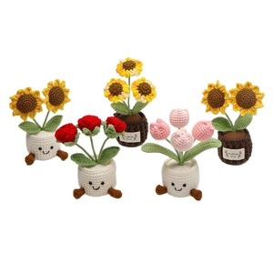 Handmade crochet potted plants with sunflowers, roses and tulips in woven pots