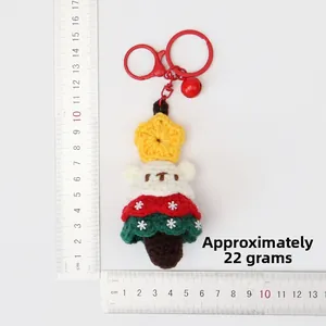 Detail shot of crochet Christmas bear charm with ruler showing 11cm height and 22g weight