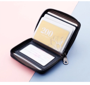 Detail view of black litchi pattern leather card holder with 20 accordion slots and zipper