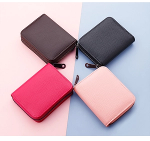 Detailed top view of 4 colorful pebbled leather card holders with metallic zippers