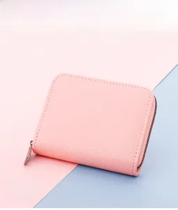 Pink lychee texture leather card holder with a secure silver metal zipper closure