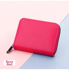 Detail of rose red zipper card holder showing premium pebble grain leather texture