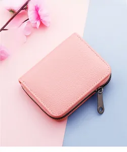 Close-up of pink litchi leather texture and durable dark grey zipper on card holder