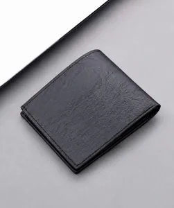 Close-up of black leather wallet showing detailed lychee texture and fine stitching