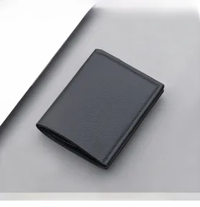 Close-up of black lychee grain leather wallet showing precise stitching and premium texture