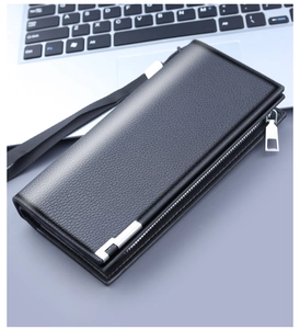 Detail of black pebbled leather men's clutch featuring silver zipper and wrist strap