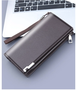 Detail of dark brown pebble leather men's clutch with double zippers and wrist strap