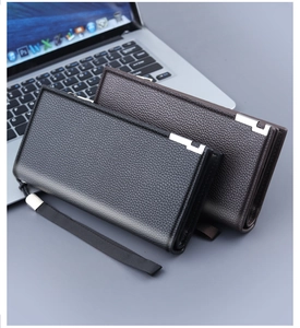 Detail of black and brown lychee grain leather clutches with silver metal L-accents