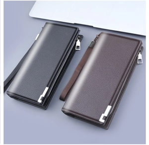 Detail of lychee textured leather wallets in black and brown with secure zipper straps