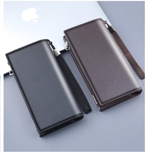 Detail of lychee pattern leather men's zip clutch with metallic hardware and wrist strap