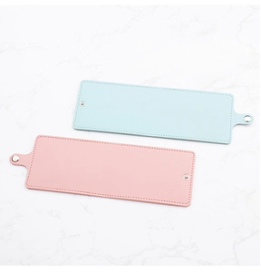 Detail view of pink and blue PU leather strap organizers with silver snap buttons