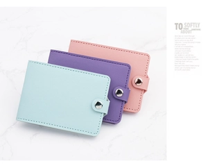 Close-up of lychee textured slim card holders in blue, purple, and pink leather finishes