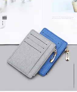 Detailed view of canvas card holders with multiple slots and metal zippers in gray and blue