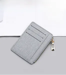 Detail of ultra-slim gray canvas card holder with three slots and golden zipper