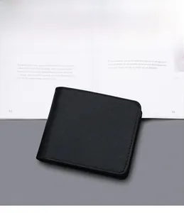 Close-up of black Saffiano leather men's wallet showing premium texture and bi-fold design
