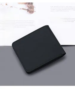 Close-up of black Saffiano leather texture and neat stitching on men's slim bifold wallet