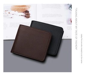Detail of slim bi-fold wallets in black and dark brown Saffiano leather texture