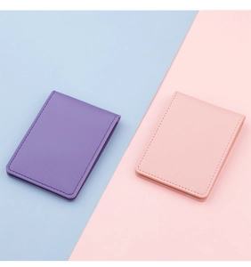 Close-up of pink and purple faux leather vehicle document holders with fine stitching details