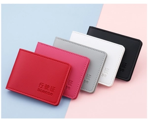 Detailed view of colorful leather vehicle license holders with textured lychee pattern