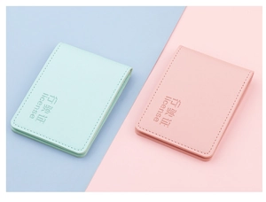Detailed macro view of mint green and pink PU leather vehicle license holders with embossing
