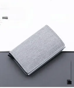 Detail of grey canvas RFID metal card holder with precise stitching and slim profile