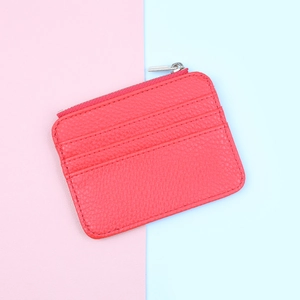 Detailed view of red pebble leather zipper card holder with three vertical card slots