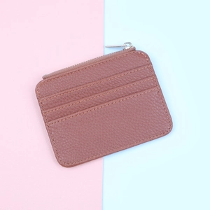 Detailed close-up of brown litchi grain leather card holder with zip pocket and 3 slots