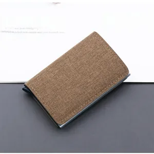Close-up of brown canvas RFID card holder with automatic pop-up mechanism and metal frame