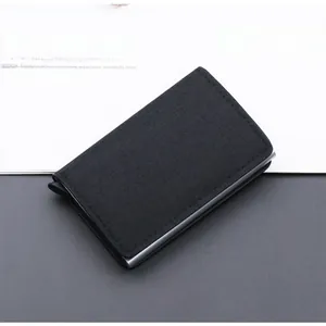 Close-up of black canvas RFID blocking metal pop-up wallet showing textured fabric and silver slot