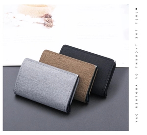 Three canvas RFID card holders in grey, brown, and black with automatic pop-up mechanism
