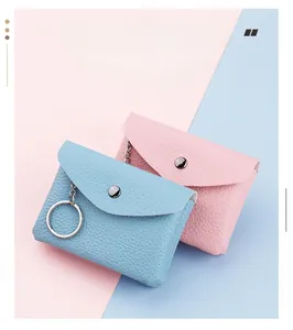 Detail of PU leather mini coin purses in pink and blue with metal keychains