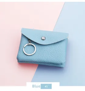 Close-up of light blue lychee grain leather coin purse with silver snap and keychain