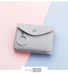 Detail of gray litchi texture leather coin purse with metal keychain and snap closure