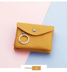 Detail of yellow pebble leather coin purse with silver metal clasp and key ring