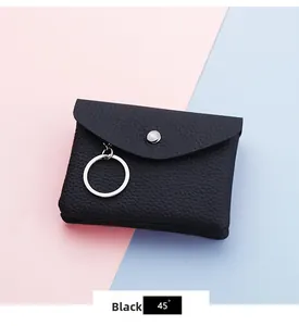 Detail of black pebbled PU leather mini coin purse with silver snap and keychain ring