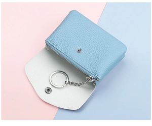Detail view of light blue lychee pattern leather coin purse with interior metal key ring