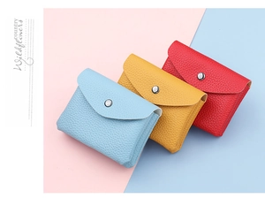 Detailed macro view of litchi textured faux leather coin purses with metal snap closure
