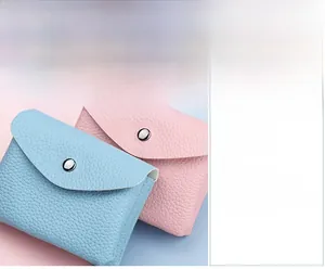 Close-up of lychee grain PU leather texture on mini coin purses with silver snap closure