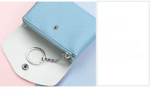 Detail of light blue lychee pattern mini coin purse with metal keychain and zip pocket