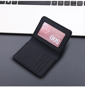 Detailed view of black canvas bifold wallet interior showing card slots and ID window