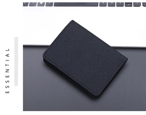Detailed view of the black canvas wallet featuring a refined woven texture and clean stitching