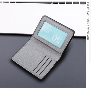 Detailed view of gray canvas wallet featuring a clear ID window and three card slots