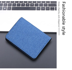 Detailed close-up of dark blue canvas men's wallet with refined stitching on desk
