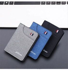 Detailed close-up of slim canvas wallets in grey, blue and black with tricolor ribbon detail