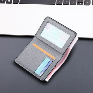 Vertical grey canvas bifold wallet for men featuring card slots and a clear ID window
