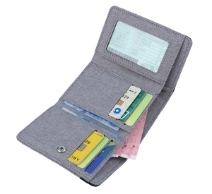 Detail of grey canvas tri-fold wallet showing multiple card slots and clear ID window