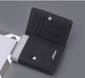 Detail view of tri-fold canvas wallet with card slots and a metal snap button closure