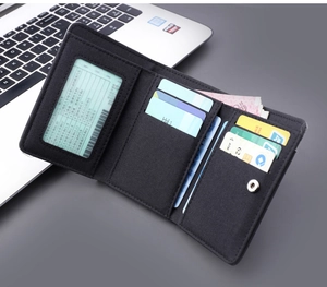 Detailed internal view of black tri-fold canvas wallet with card slots and ID window