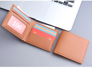 Short bi-fold men's wallet in light brown leather with card slots and a clear ID window