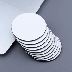 Close-up of white sublimation coasters with anti-slip rubber base for DIY heat press printing